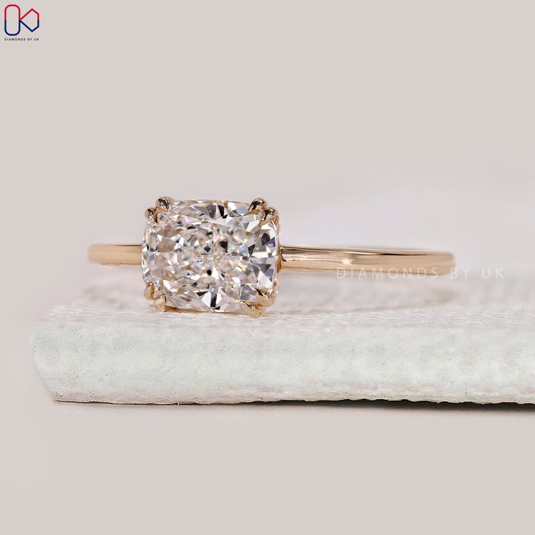 Yellow gold diamond ring with radiant cut centre stone.
