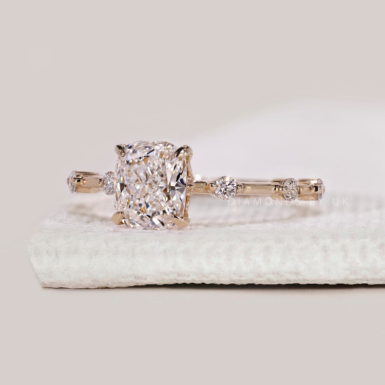 Yellow gold diamond ring with elongated cushion cut.
