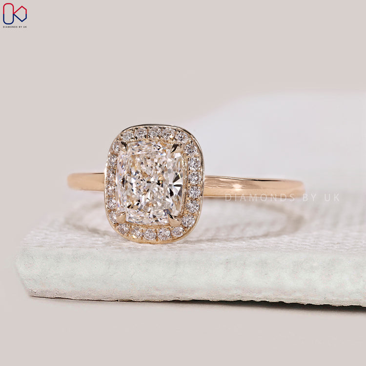 Round cut halo style engagement ring in yellow gold.
