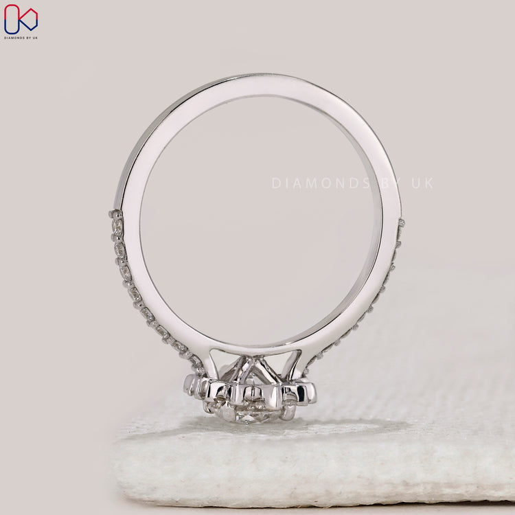 Cathedral setting round diamond engagement ring.
