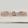 Channel set round diamond band in yellow gold.
