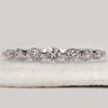 Diamond half eternity band crafted in white gold with seven round diamonds.
