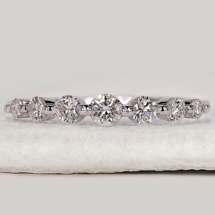 Diamond half eternity band crafted in white gold with seven round diamonds.
