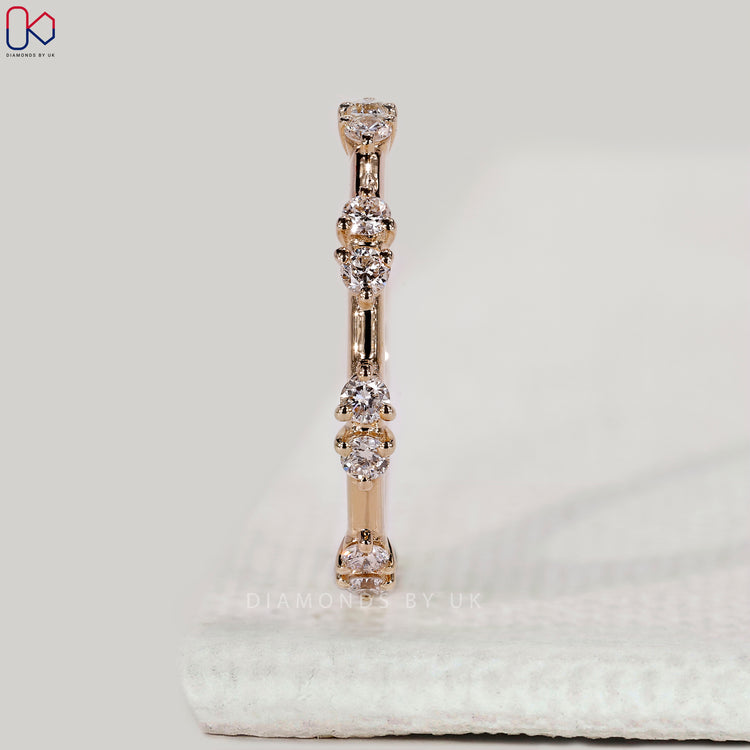 Prong setting wedding band with round cut diamonds.
