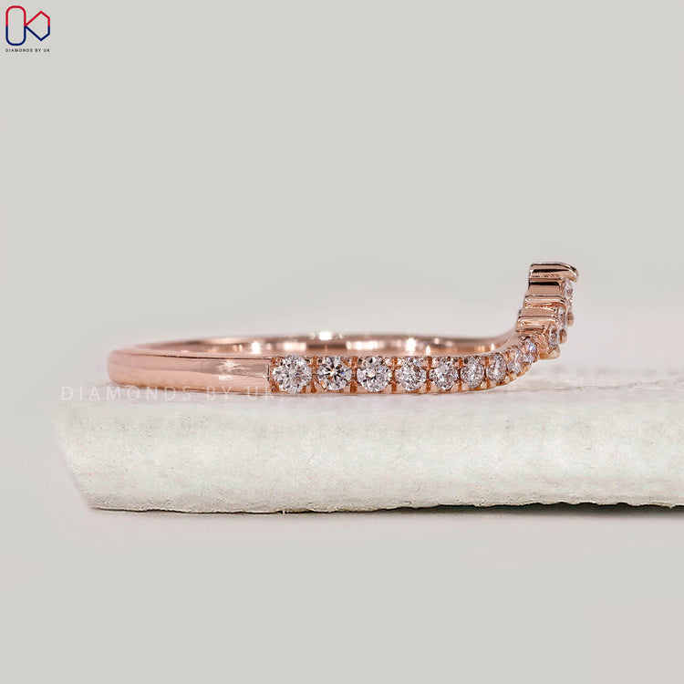 Rose gold wedding band with prong setting.
