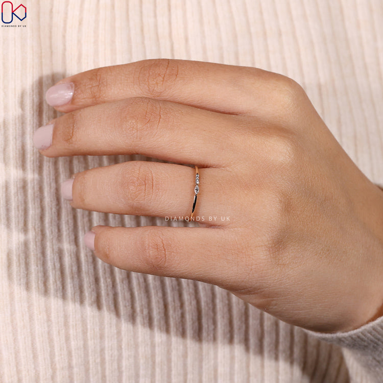 Dainty wedding band with four handcrafted diamonds set in yellow gold.
