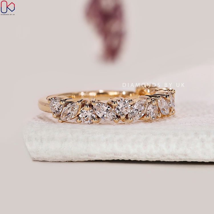 Alternating marquise diamond wedding band in yellow gold for a bold half eternity look.
