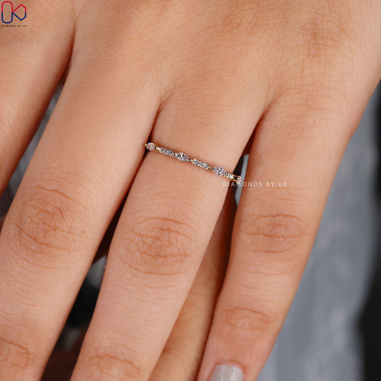 Prong set wedding band created with lab grown marquise and round diamonds.
