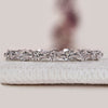 Marquise and round diamond wedding band with shared prongs.
