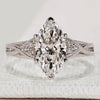 Marquise ring with round side stones and muse style.
