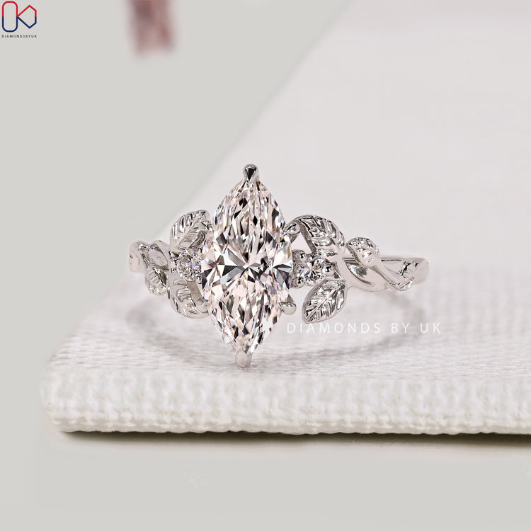 Nature inspired marquise diamond ring with side stones.
