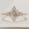 Marquise cut diamond ring with kite and round side stones.
