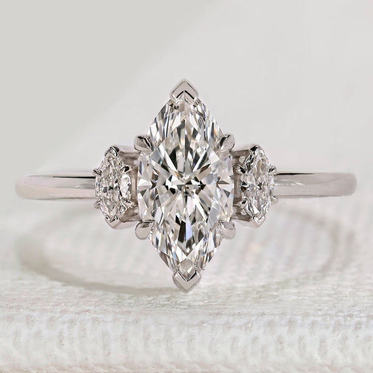 Marquise cut three stone ring with side stones.
