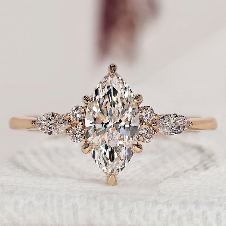 Marquise cut ring with round side stones design.