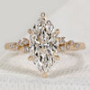 Marquise engagement ring with round side stones.