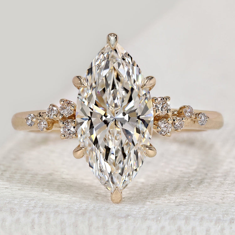 Marquise engagement ring with round side stones.
