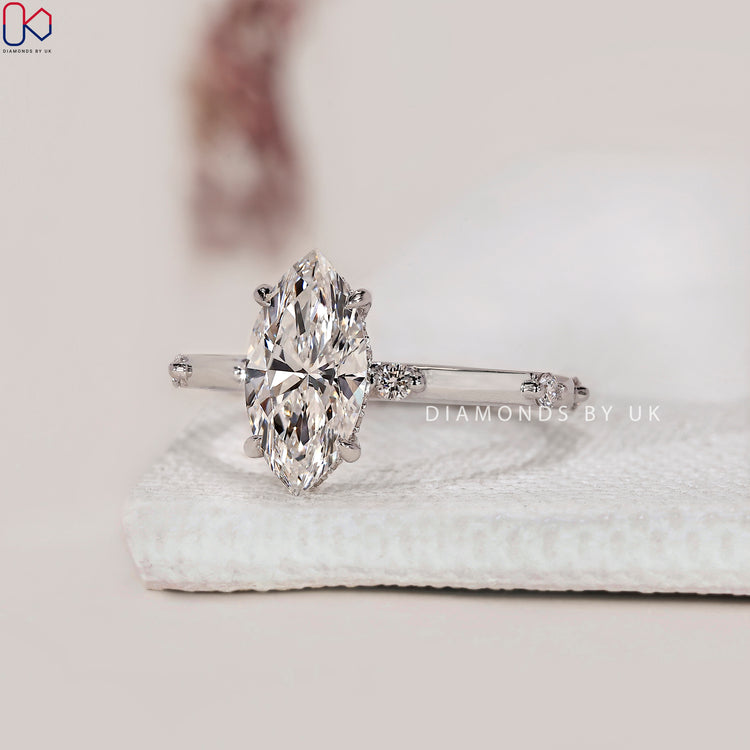Marquise cut engagement ring with hidden diamond halo.