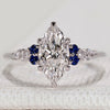 Marquise ring with blue sapphire and side stones.
