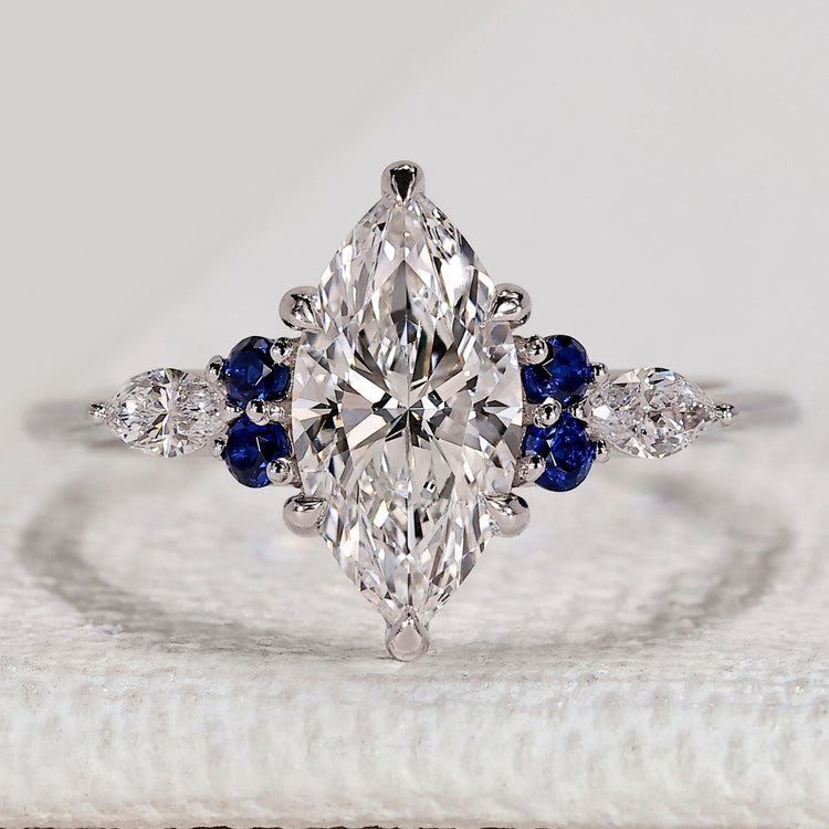 Marquise ring with blue sapphire and side stones.
