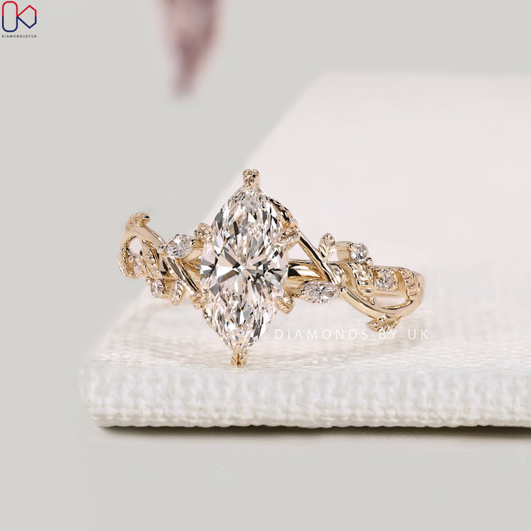 Nature inspired marquise diamond ring with leaf prongs.
