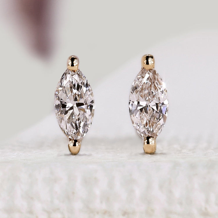 Marquise diamond earrings with stud and solitaire style.