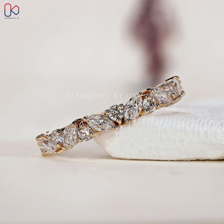 Marquise diamond wedding band crafted with alternating shapes for a refined half eternity look.
