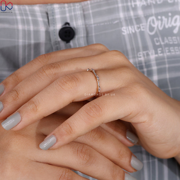 Minimalist wedding band crafted for stacking, featuring soft curves and fine detail.
