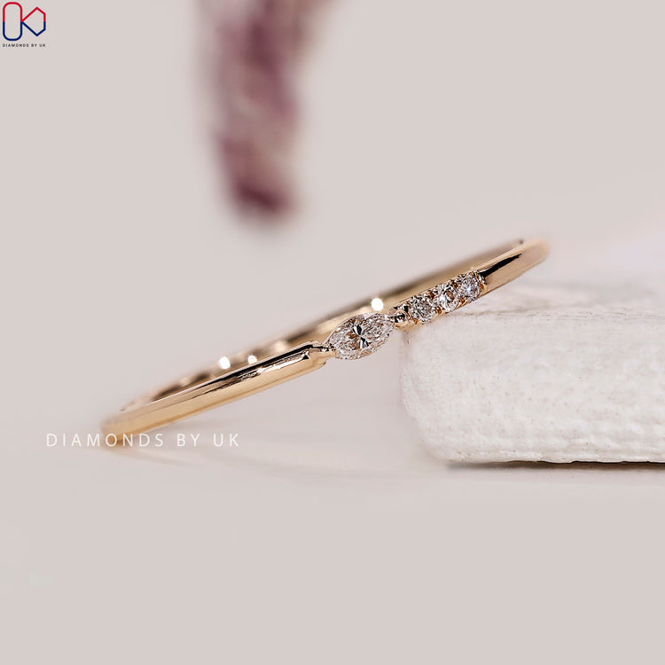 Four stone wedding band made in yellow gold for a dainty, handcrafted finish.
