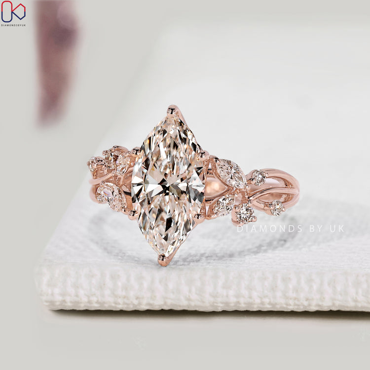 Marquise diamond ring with round and marquise side stones.
