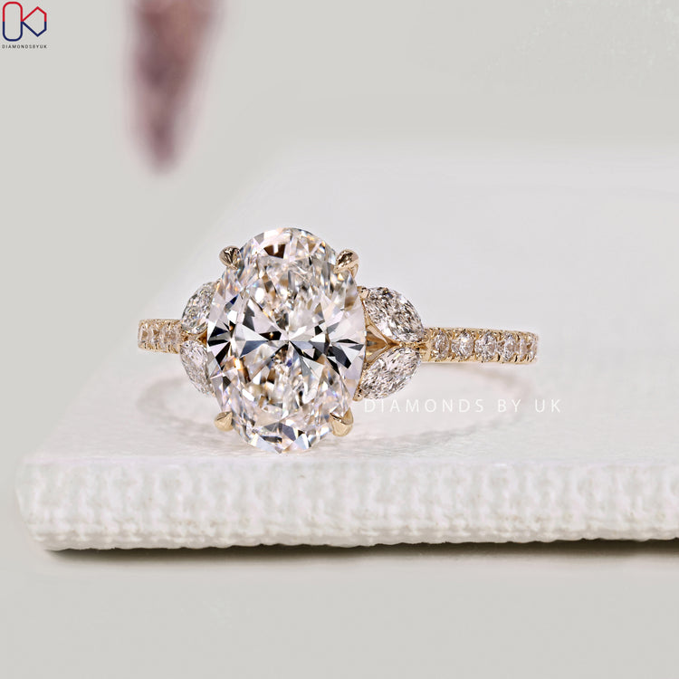 Oval cut diamond ring with round diamond pavé setting.