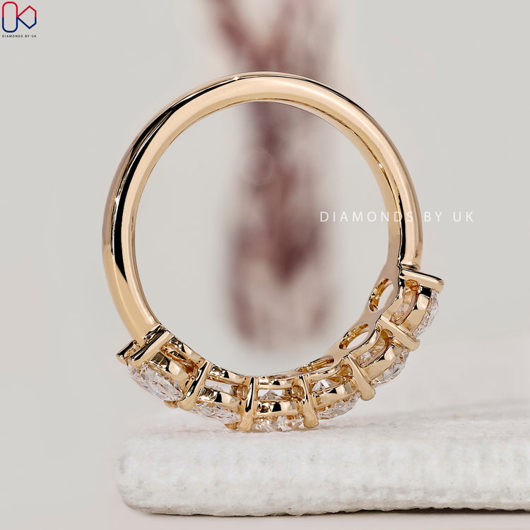 Half eternity wedding band designed with oval lab grown diamonds and handmade detailing.
