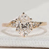 Oval cut engagement ring with round side stones.
