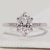 Oval cut ring with round diamond side stones.