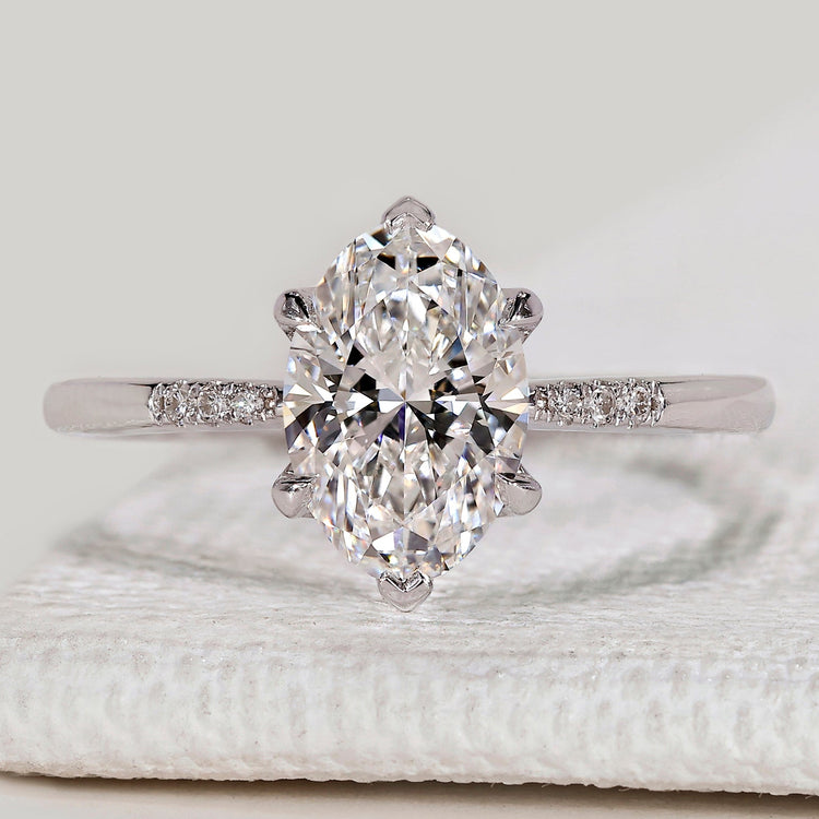 Oval cut ring with round diamond side stones.