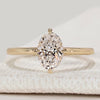 Oval cut solitaire ring with compass prong setting.