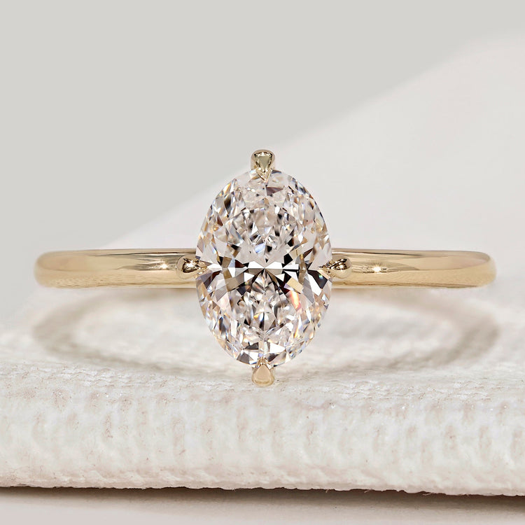 Oval cut solitaire ring with compass prong setting.