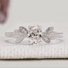 Oval cut engagement ring with round diamond side stones.