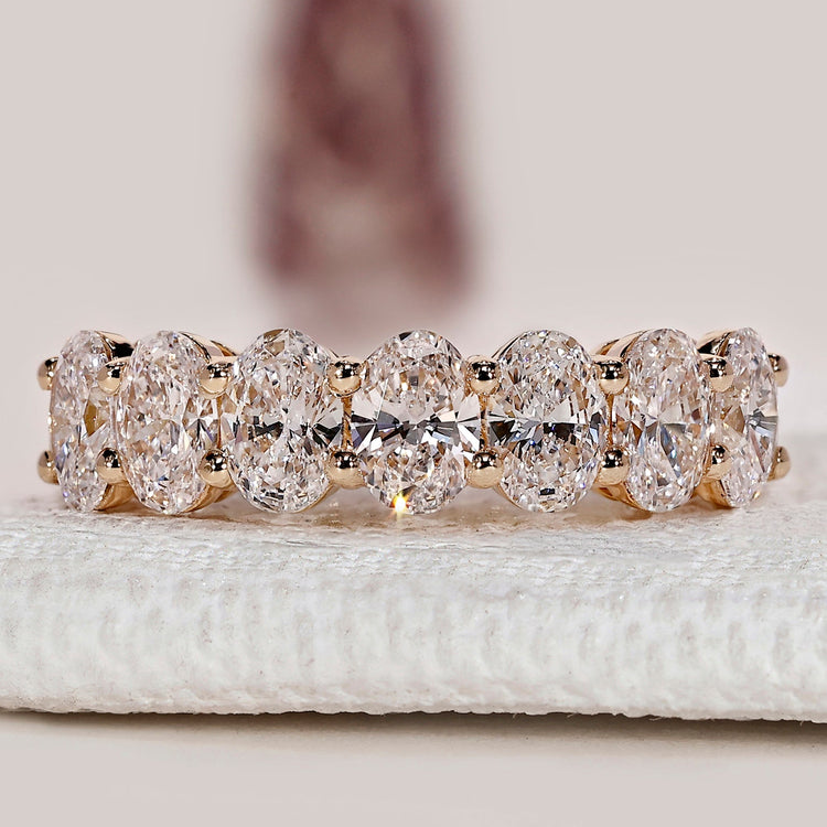 Oval cut diamond band with half eternity prong setting.
