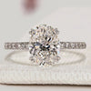 Oval cut engagement ring with hidden halo and pavé style.
