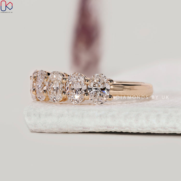 Oval diamond half eternity band featuring six lab grown stones in a prong setting.
