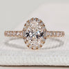Oval diamond ring with round and baguette halo style.
