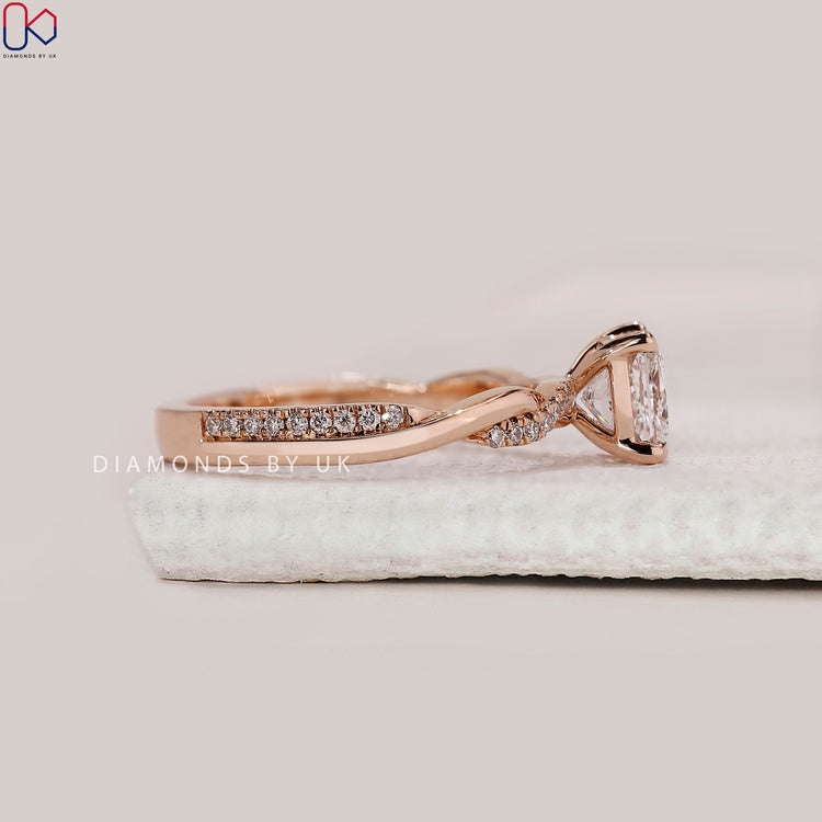 Round cut twisted pave band with princess diamond center.
