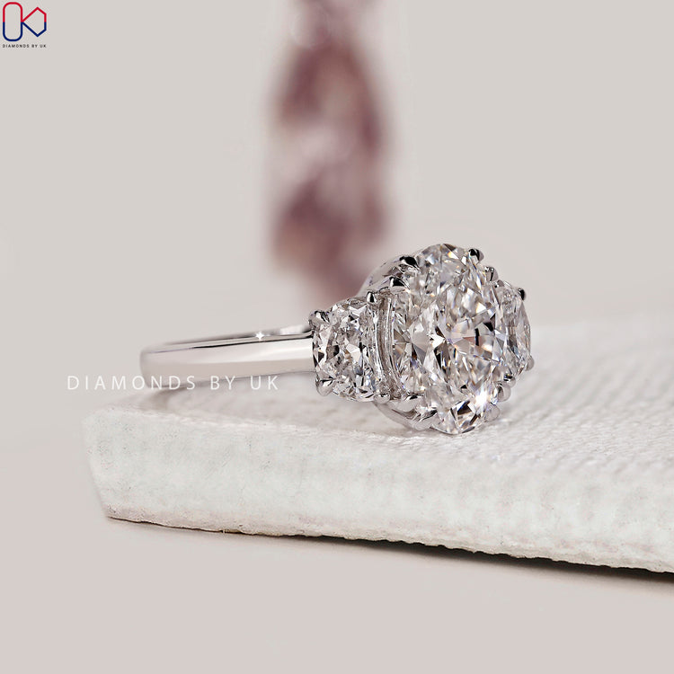 Buy engagement ring with 3 stone design and side stones.
