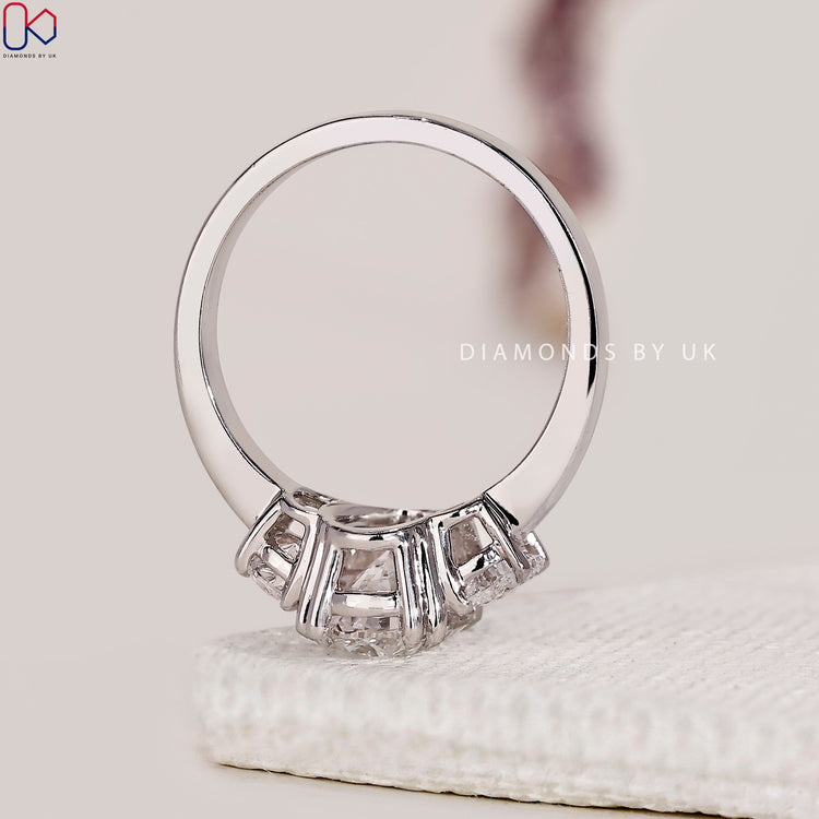 Handmade ring featuring oval diamond and side stones.
