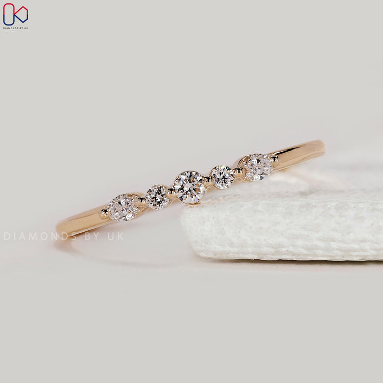 Custom diamond band with 5 oval and round stones.
