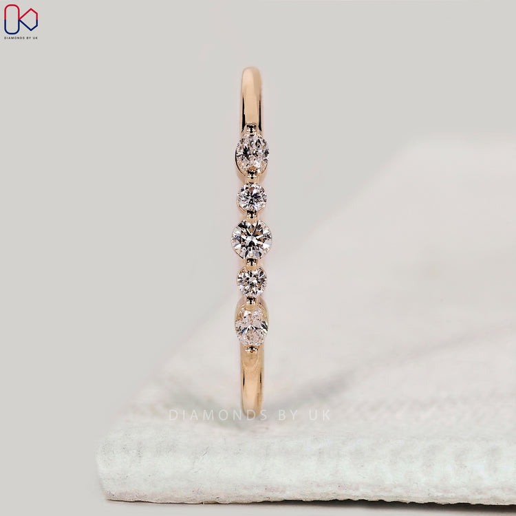 Shared prong wedding band with oval and round diamonds.
