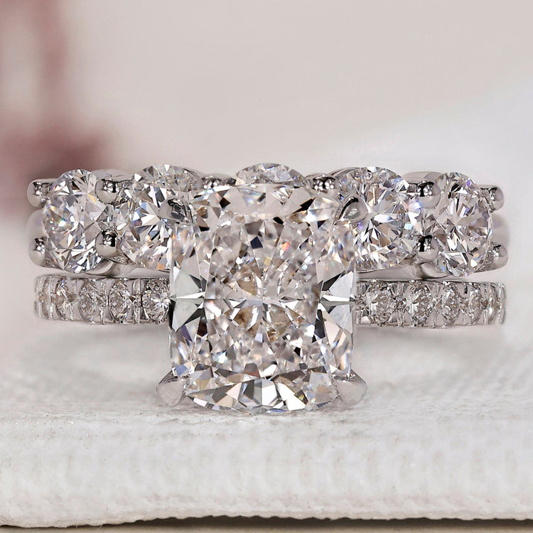 Cushion cut diamond ring and wedding band in elegant white gold.
