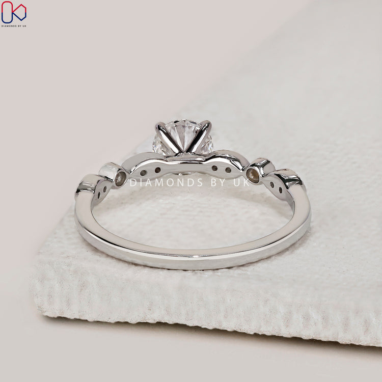 Round cut prong setting ring with milgrain accent.

