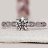 Round diamond engagement ring with milgrain setting.
