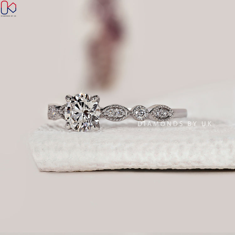 DiamondsbyUK round cut diamond ring with milgrain design.
